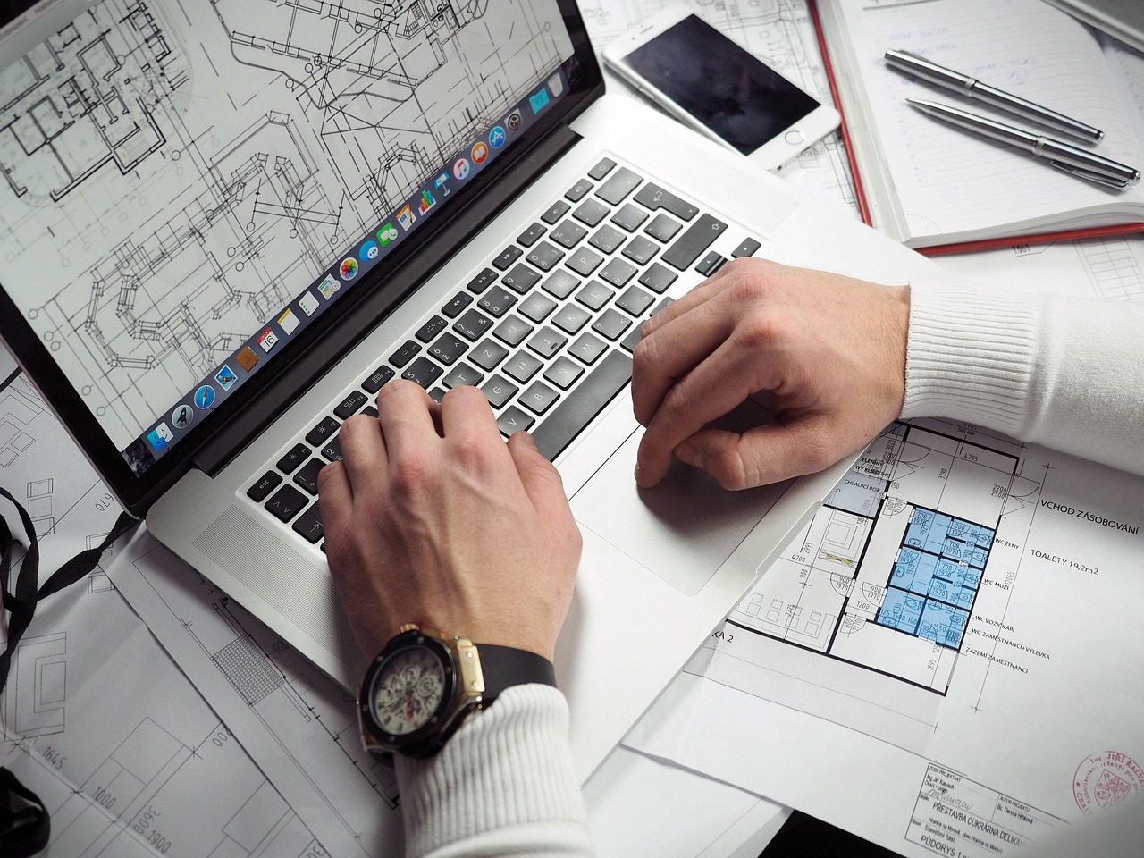 Blueprints, entrepreneur, hands — The Importance of Instant Message Monitoring and Text Message Archiving
