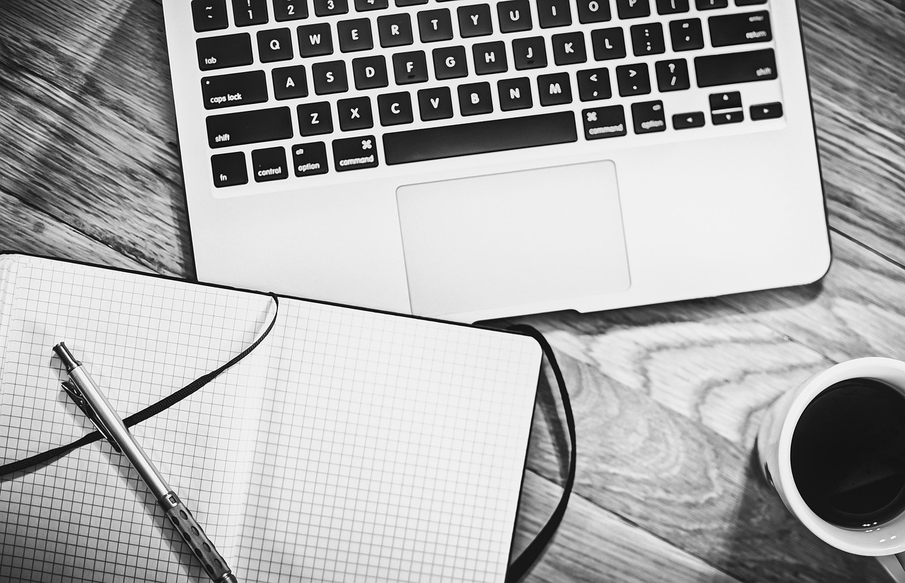 Computer, notebook, coffee — The Top Mistakes To Avoid When Setting Up A Restricted Property Trust By Kenton Crabb Charlotte